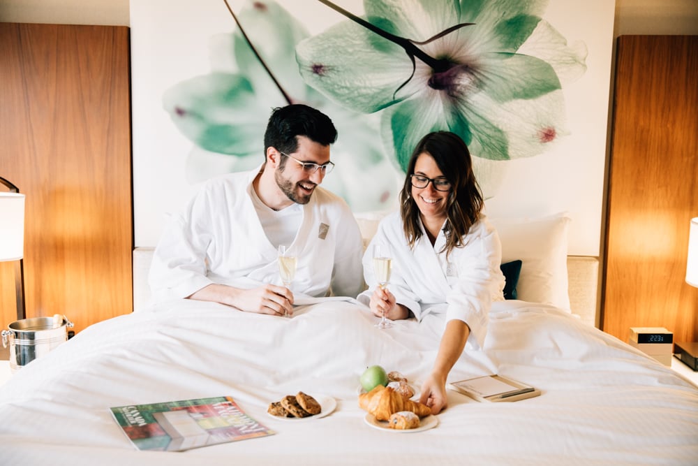 a couple eating breakfast in bed