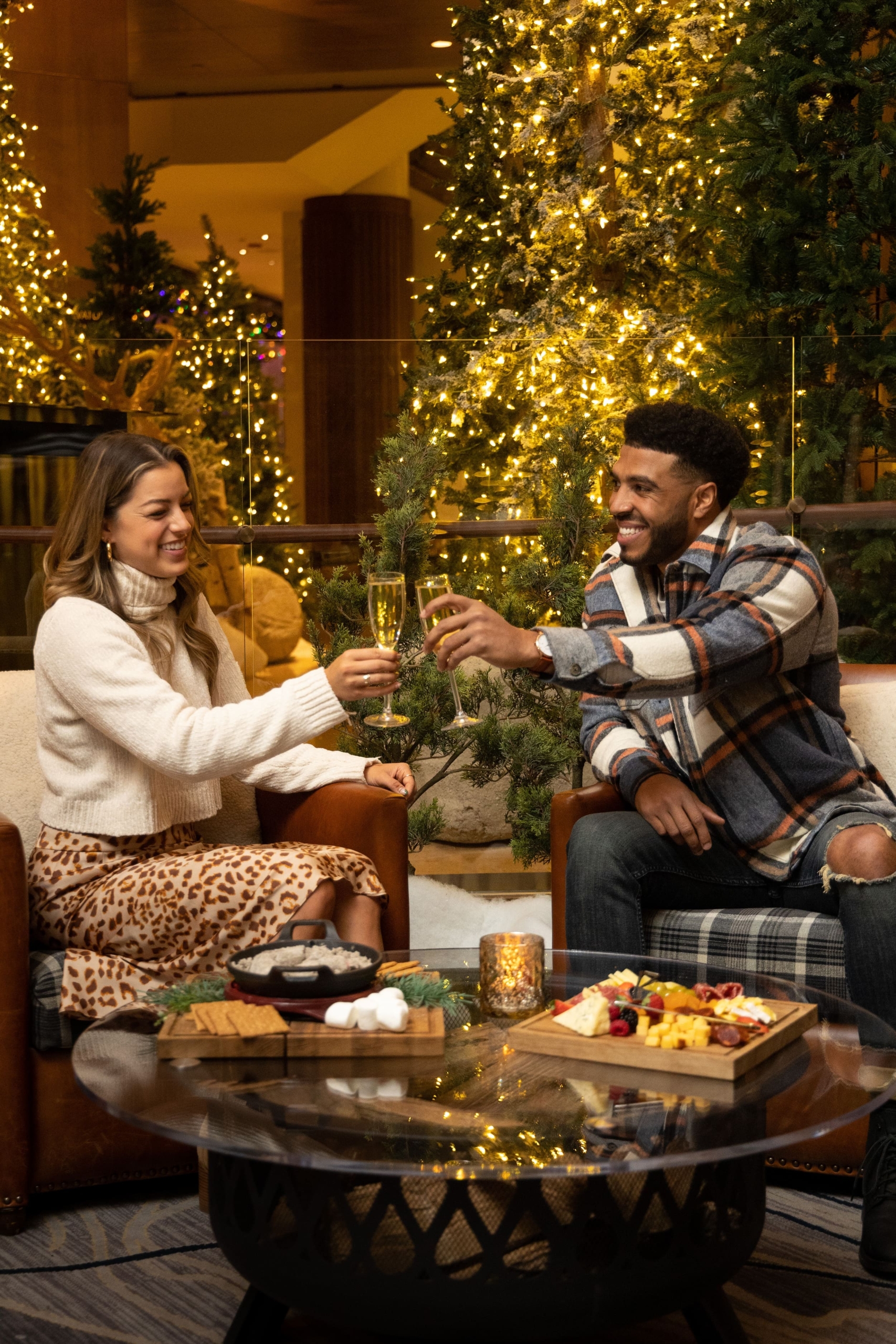a couple drinking champagne and eating a charcuterie board
